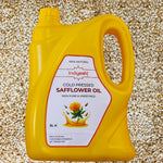 Yellow bottle of Indiyeah cold pressed safflower oil on a textured background