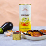 Indiyeah mustard oil can with ingredients and food items on a table